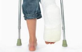 Adams Harrison Personal Injury Law picture Crutch-walking person with a plaster cast on leg for injury recovery.
